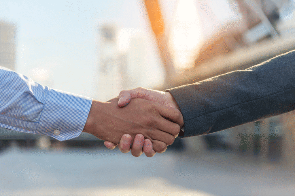 Poignée de main illustrant la valeur lu respect dans le marketing digital, la stratégie communication, la création de contenu publicitaire et la création d'identité visuelle.